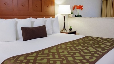 King bed with a side table and lamp in hotel room