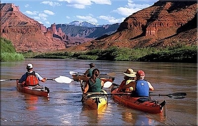 Group of people in kayaks on a river in Utah 